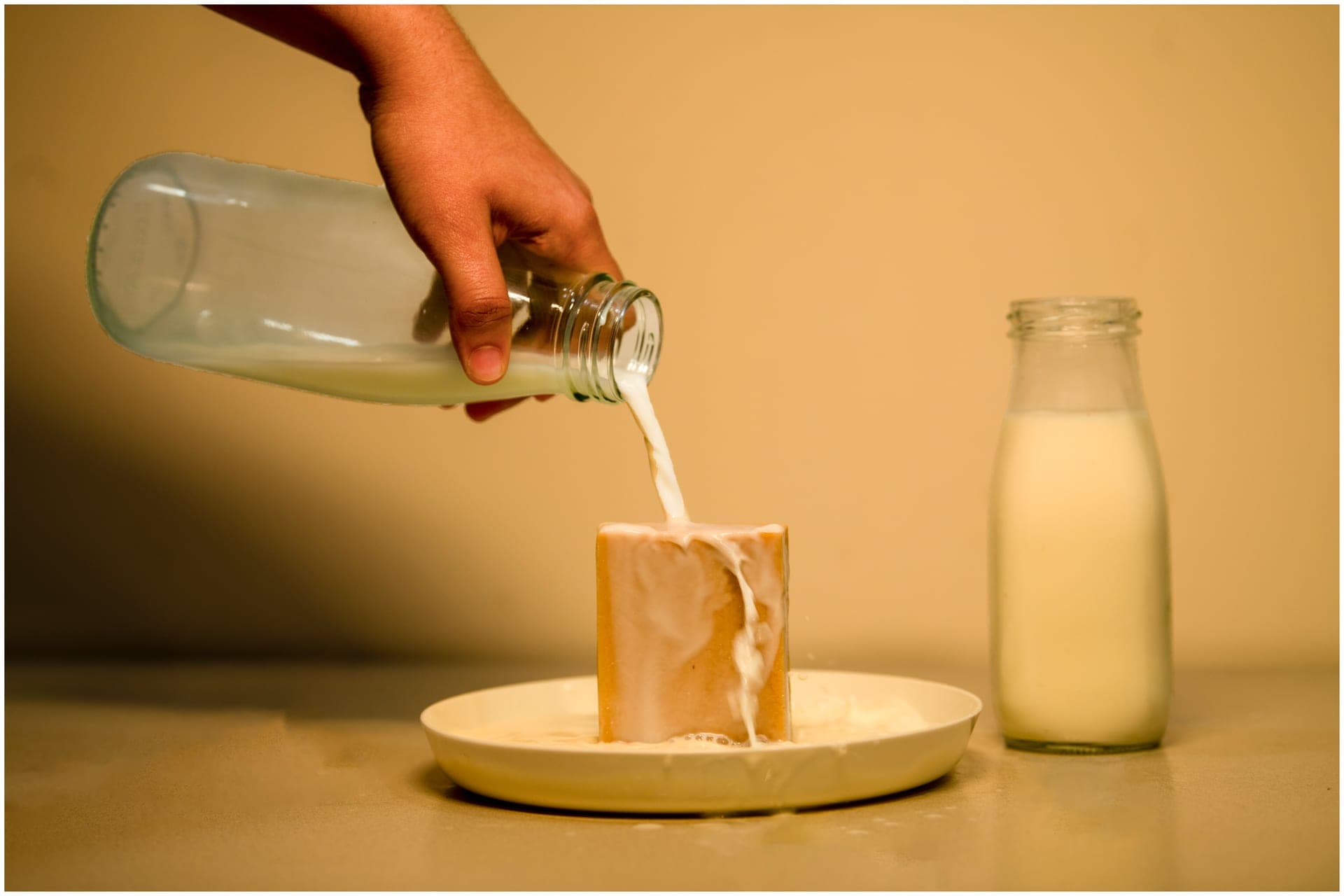 Fresh milk poured over a curing soap bar